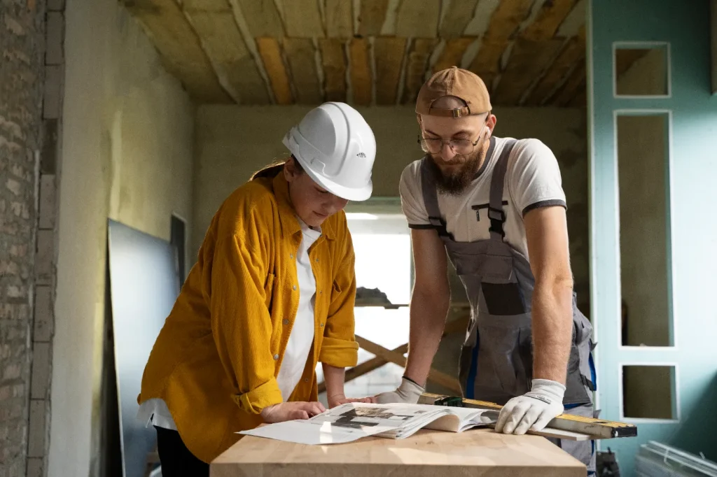 Contractors reviewing plans during a home renovation